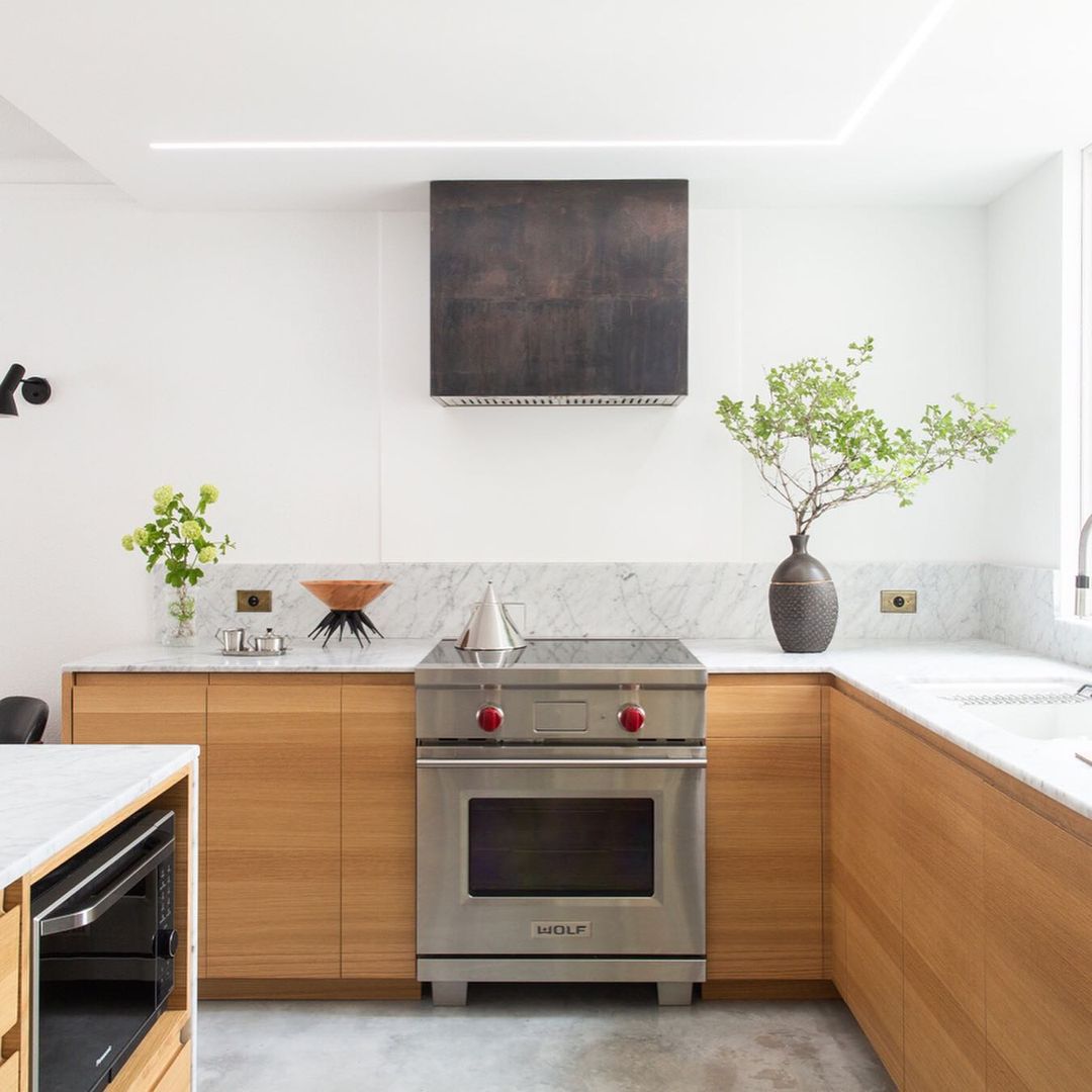A little over a year with this kitchen. The range hood and outlet covers are unlacquered brass treated with acid to accelerate patina. The linear light fixture is the largest of 5 I made for the house, and changes colour temperature throughout the day. #interiors — @bradcerasani on Instagram